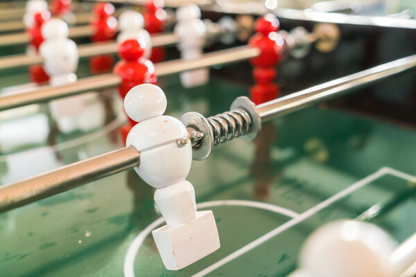 Football table game with red and white player .