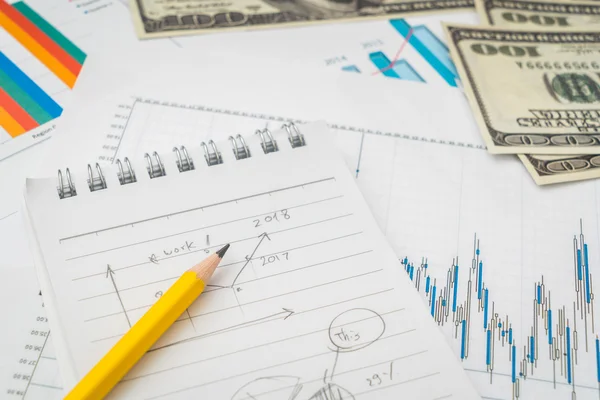 Pénzügyi térképbe rajzol az asztalon, a dollár bankjegyek . — Stock Fotó