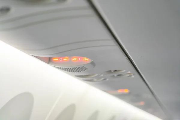 No smoking sign and seat belt sign on the airplane . — Stock Photo, Image