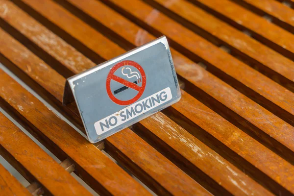 Ahşap masa üzerinde hiçbir Sigara İçilmez işareti . — Stok fotoğraf