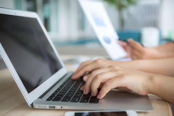 Close-up of business person use laptop with financial diagram — Stock Photo, Image