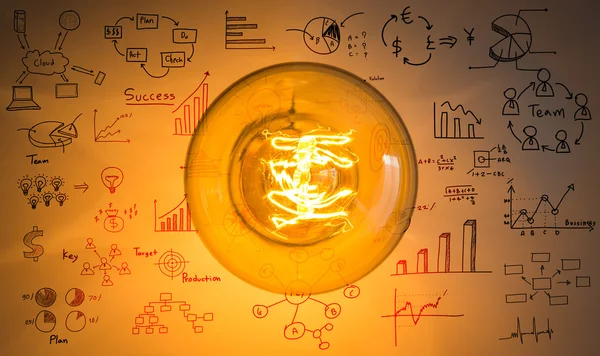 Top view of vintage glowing light bulb with drawing graph — Stock Photo, Image