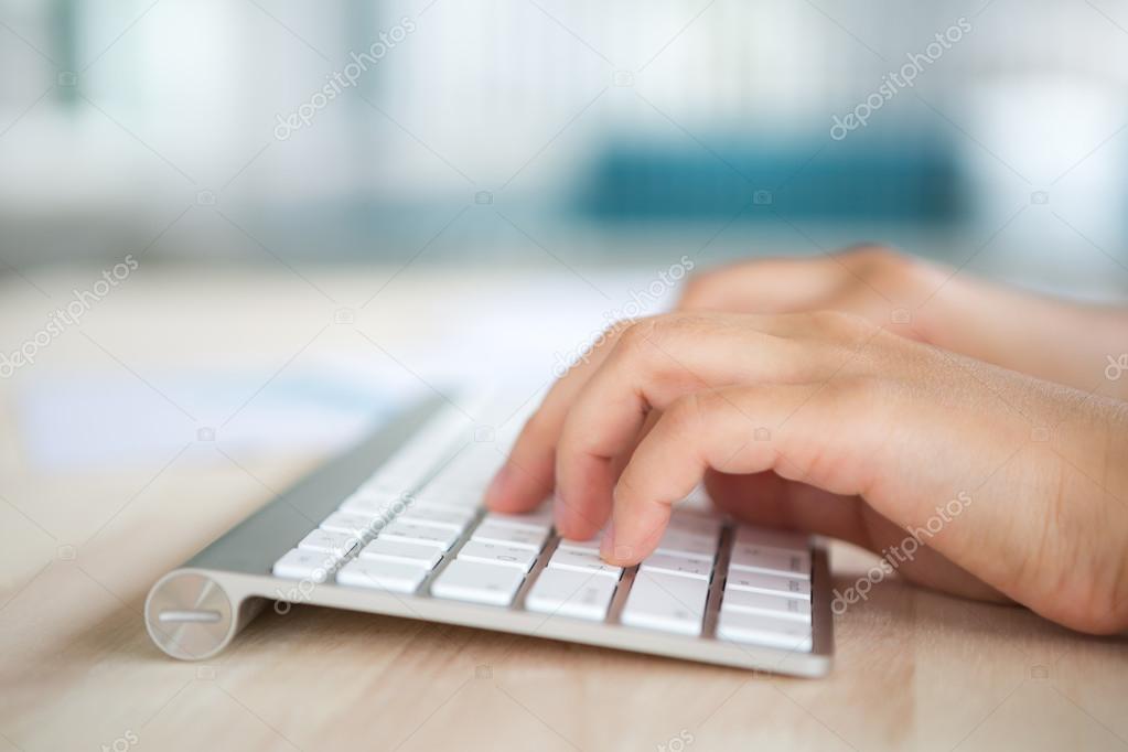 Closeup of business woman hand typing on keyboard