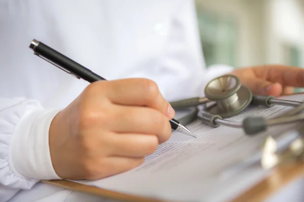 Mano del médico escribiendo sobre la prescripción — Foto de Stock