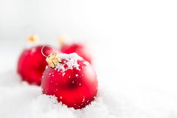 Red christmas balls with snow — Stock Photo, Image