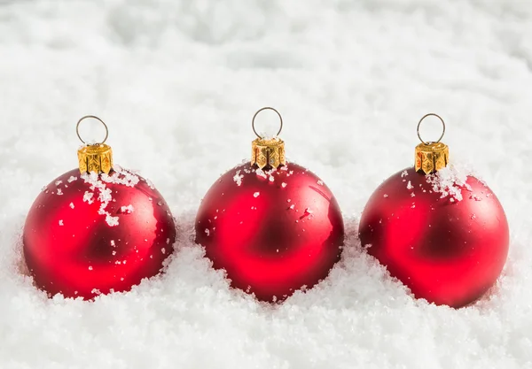 Red christmas balls with snow — Stock Photo, Image