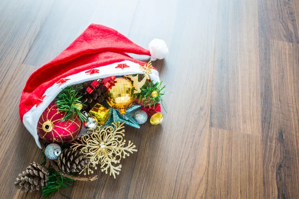 Santa Hat with Christmas decorations on wooden background — Stock Photo, Image