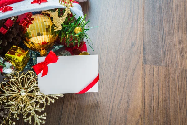 Christmas card and Santa Hat with decorations on wooden backgrou — Stock Photo, Image