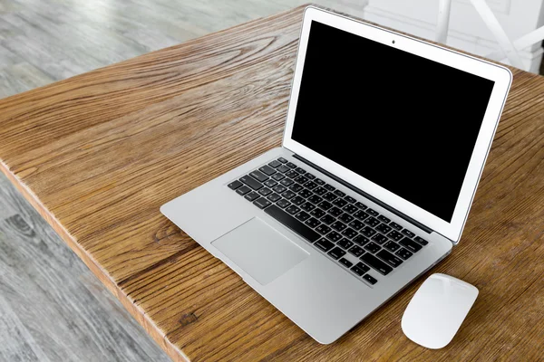 Blank skärm bärbar dator på bord av trä — Stockfoto