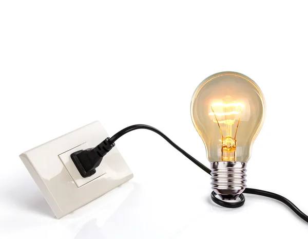 Light bulb and a plug with a cord — Stock Photo, Image