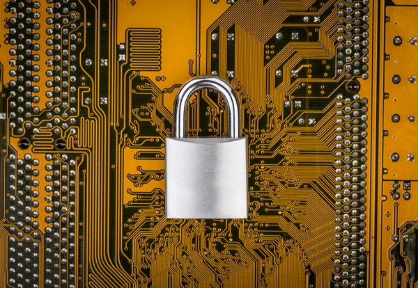 Protection concept : security lock on computer circuit board — Stock Photo, Image