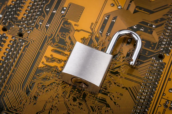 Protection concept : security lock on computer circuit board — Stock Photo, Image