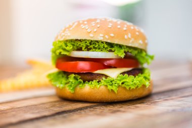 Hamburger üzerinde ahşap masa, güneş flare filtre efekti