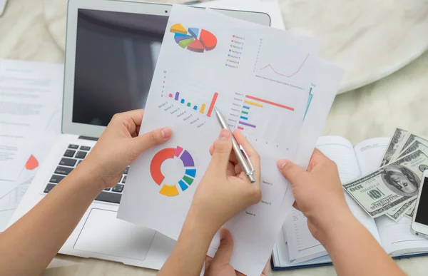 Group of business people pointing at business document during me — Stock Photo, Image