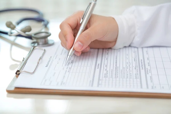 Hand of doctor writing on prescription — Stock Photo, Image