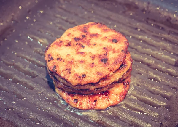 Hamburgers in a grill pan ( Filtered image processed vintage eff — Stock Photo, Image