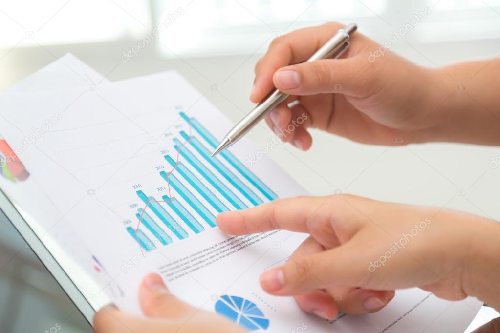 Group of business people pointing at business document