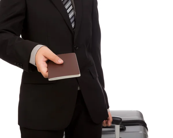 Business traveling pulling suitcase and holding passport — Stock Photo, Image