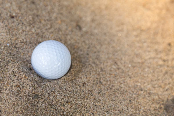 Golf ball in sand bunker — Stock Photo, Image