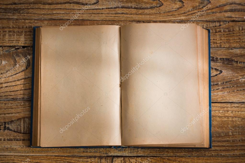 Open blank pages of old book on wood background Stock Photo by  ©jannystockphoto 76514339