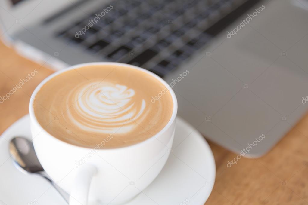 laptop with coffee cup on old wooden table ( Filtered image proc