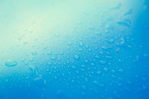 Gotas de agua en el suelo azul — Foto de Stock