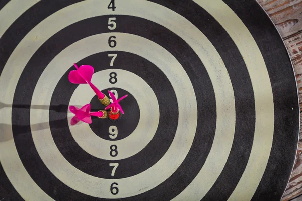 Dartboard on wood wall — Stock Photo, Image