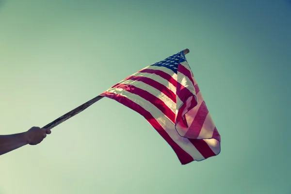 American flag with stars and stripes hold with hand — Stock Photo, Image