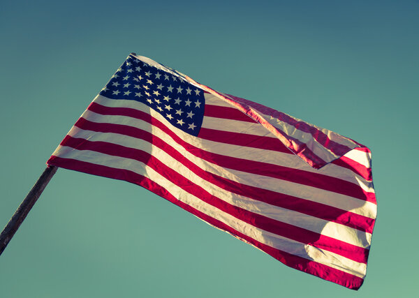 American flag over blue sky