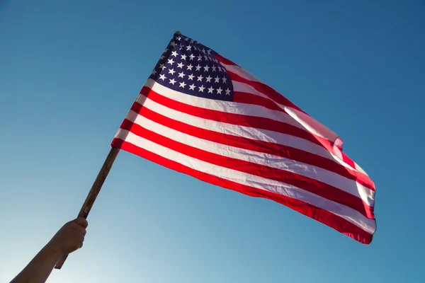 American flag with stars and stripes hold with hand — Stock Photo, Image