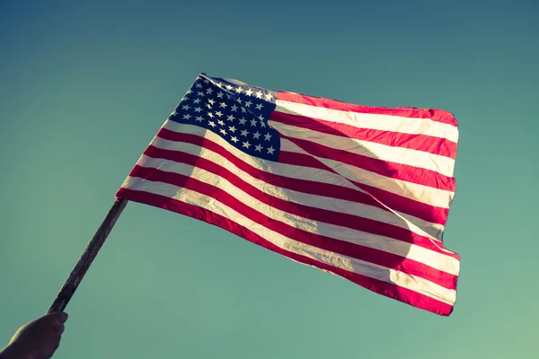 American flag with stars and stripes hold with hand — Stock Photo, Image