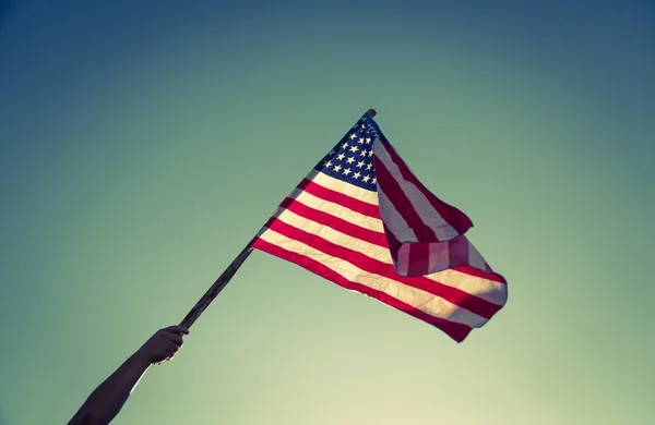 American flag with stars and stripes hold with hand — Stock Photo, Image