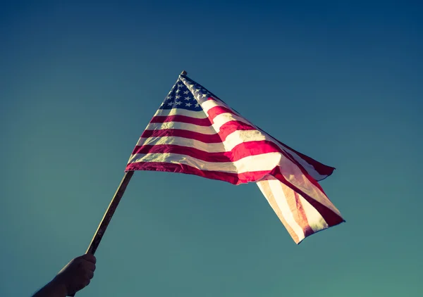 American flag with stars and stripes hold with hand — Stock Photo, Image