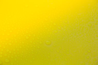 Sarı zemin üzerinde su damlaları