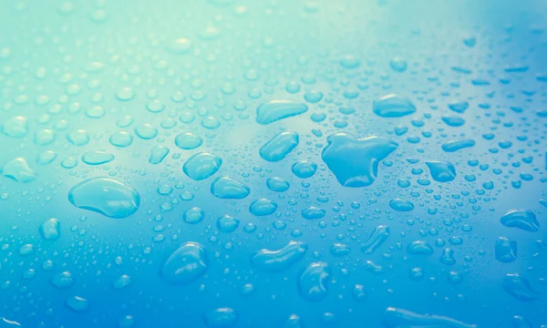 Gotas de agua en el suelo azul —  Fotos de Stock