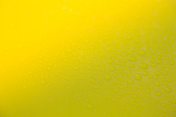 Drops of water on yellow floor — Stock Photo, Image