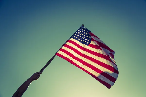 American flag with stars and stripes hold with hand — Stock Photo, Image