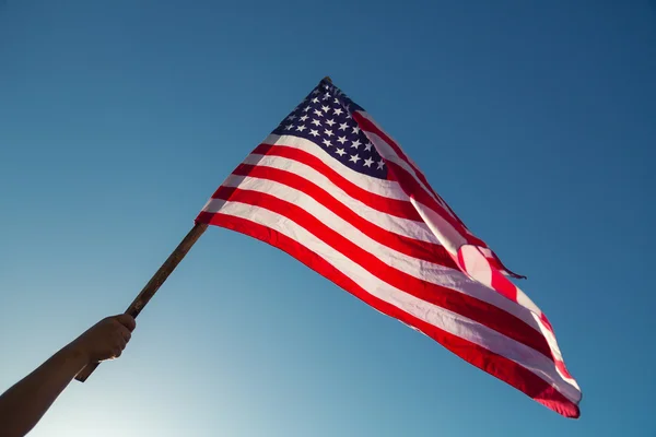 American flag with stars and stripes hold with hand — Stock Photo, Image