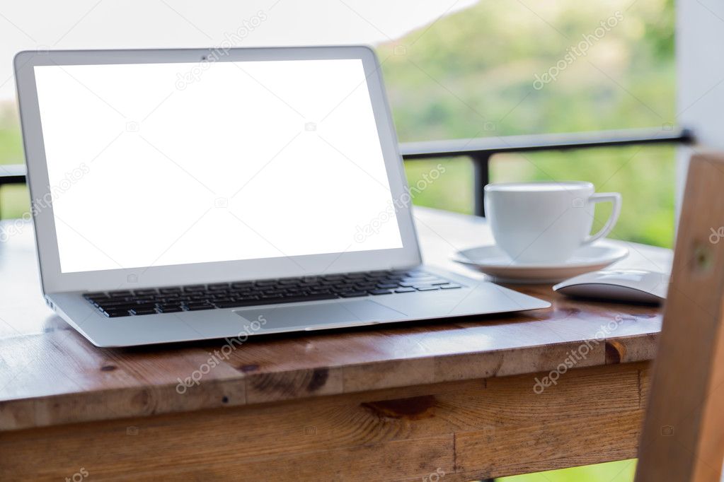 laptop with coffee cup on old wooden table