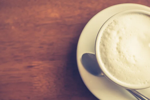 Hot latte art coffee on table