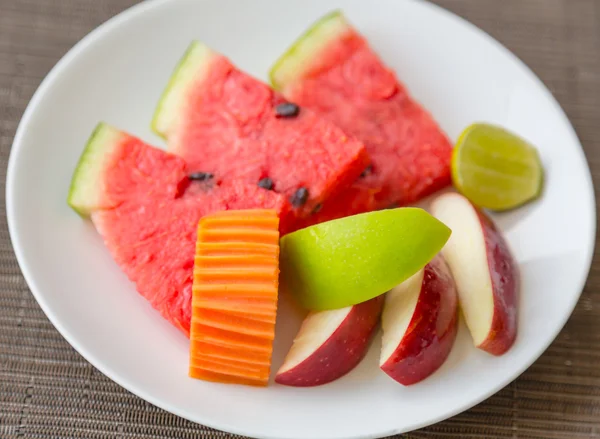 Fruits on white plate — Stock Photo, Image