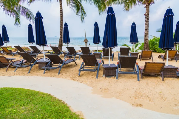 Beach chairs and umbrella on sand beach — Stock Photo, Image