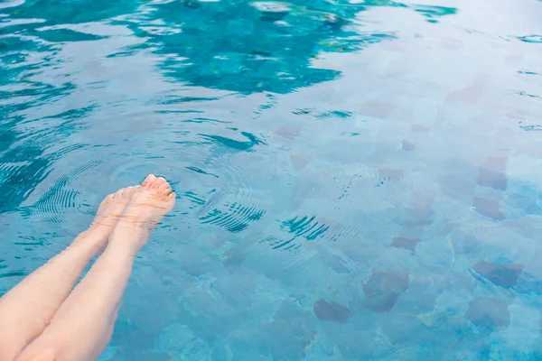 Female legs in the swimming pool water — Stock Photo, Image