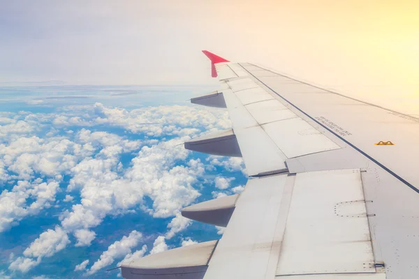 Airplane flying above clouds — Stock Photo, Image