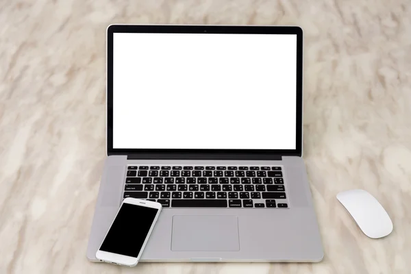 Laptop with smartphone on table — Stock Photo, Image