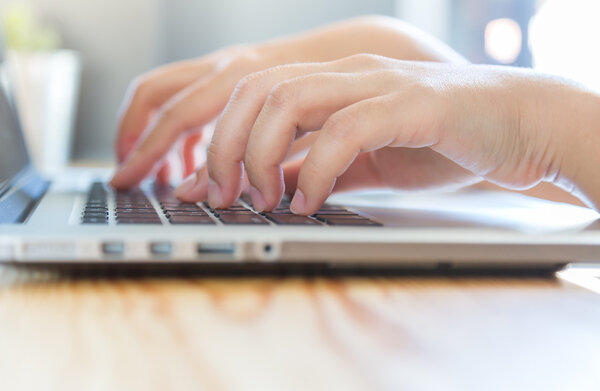 businesswoman hands typing on laptop