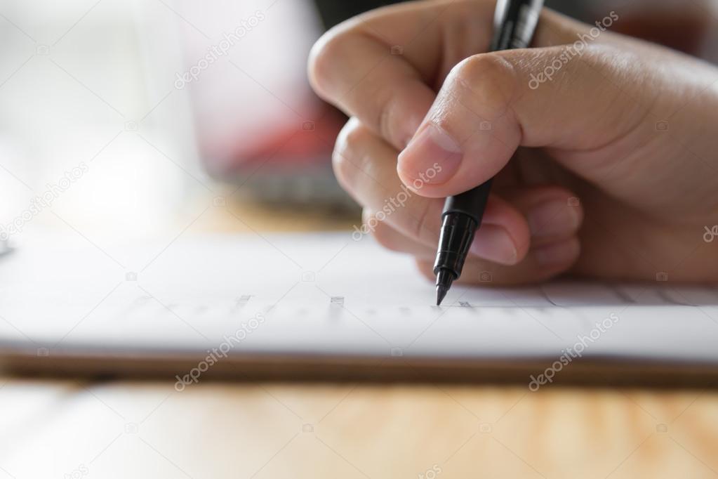 Hand with black pen