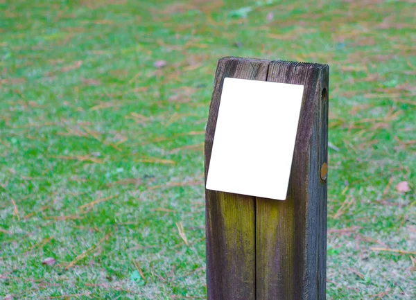 Wooden sign on grass — Stock Photo, Image