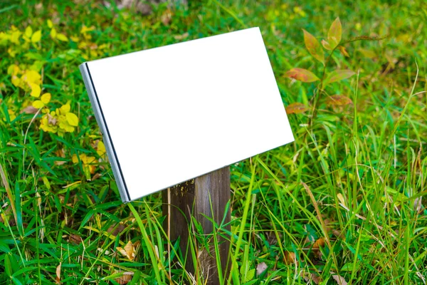 Wooden sign on grass — Stock Photo, Image