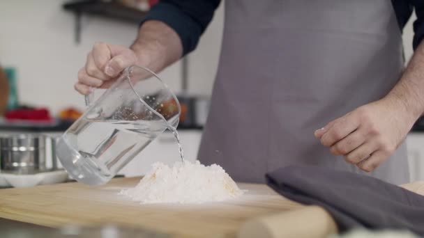 O chef de avental amassa a massa. Close-up de uma mão cozinheiros. — Vídeo de Stock
